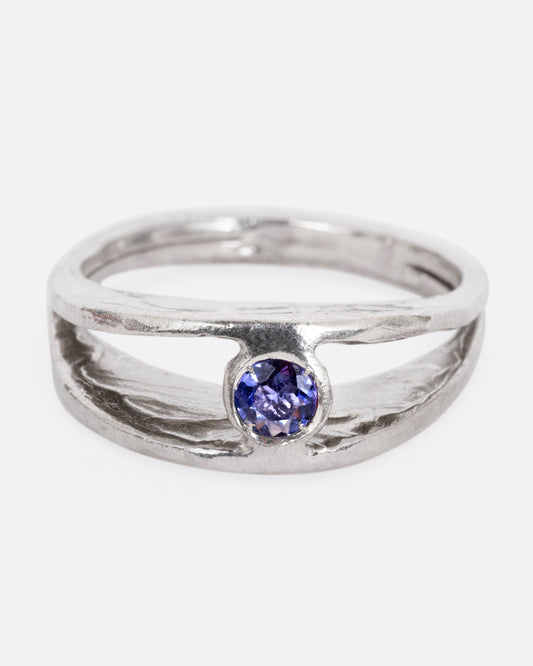 A silver ring with a split shank and a center iolite, shown from the front.