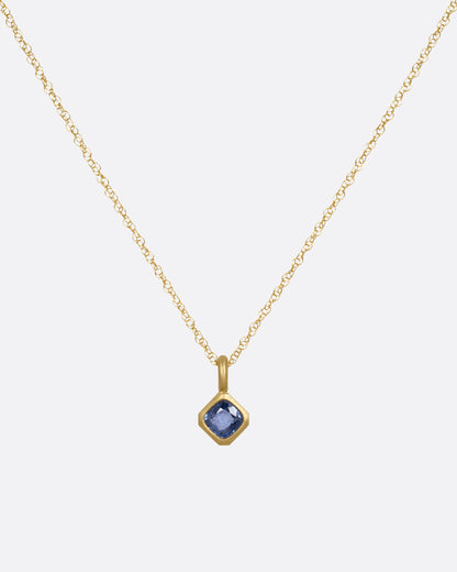 Yellow gold blue sapphire pendant necklace, front view of the pendant on its chain