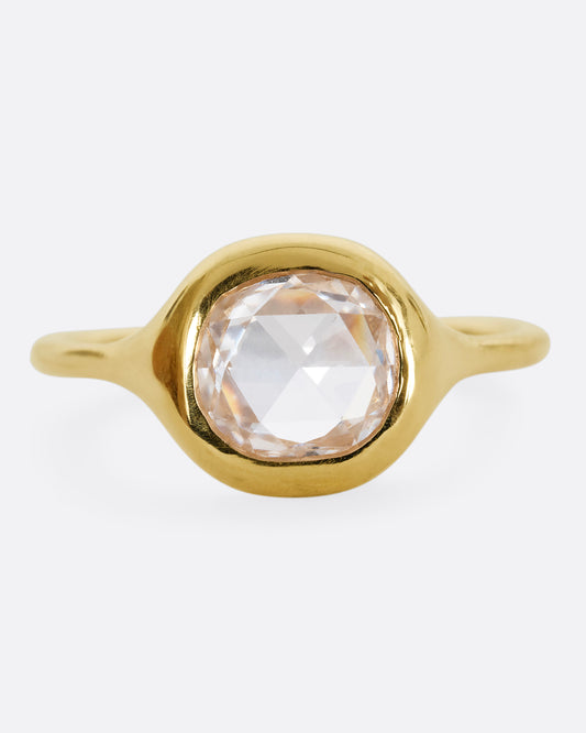 A yellow gold hand carved ring with a brilliant rose cut diamond. Shown from the front.