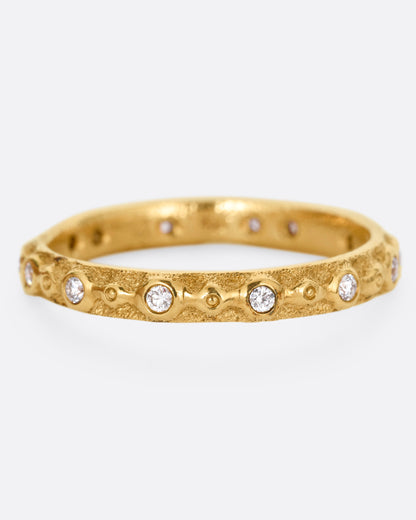 A textured yellow gold ring with white diamonds. Shown from the front.