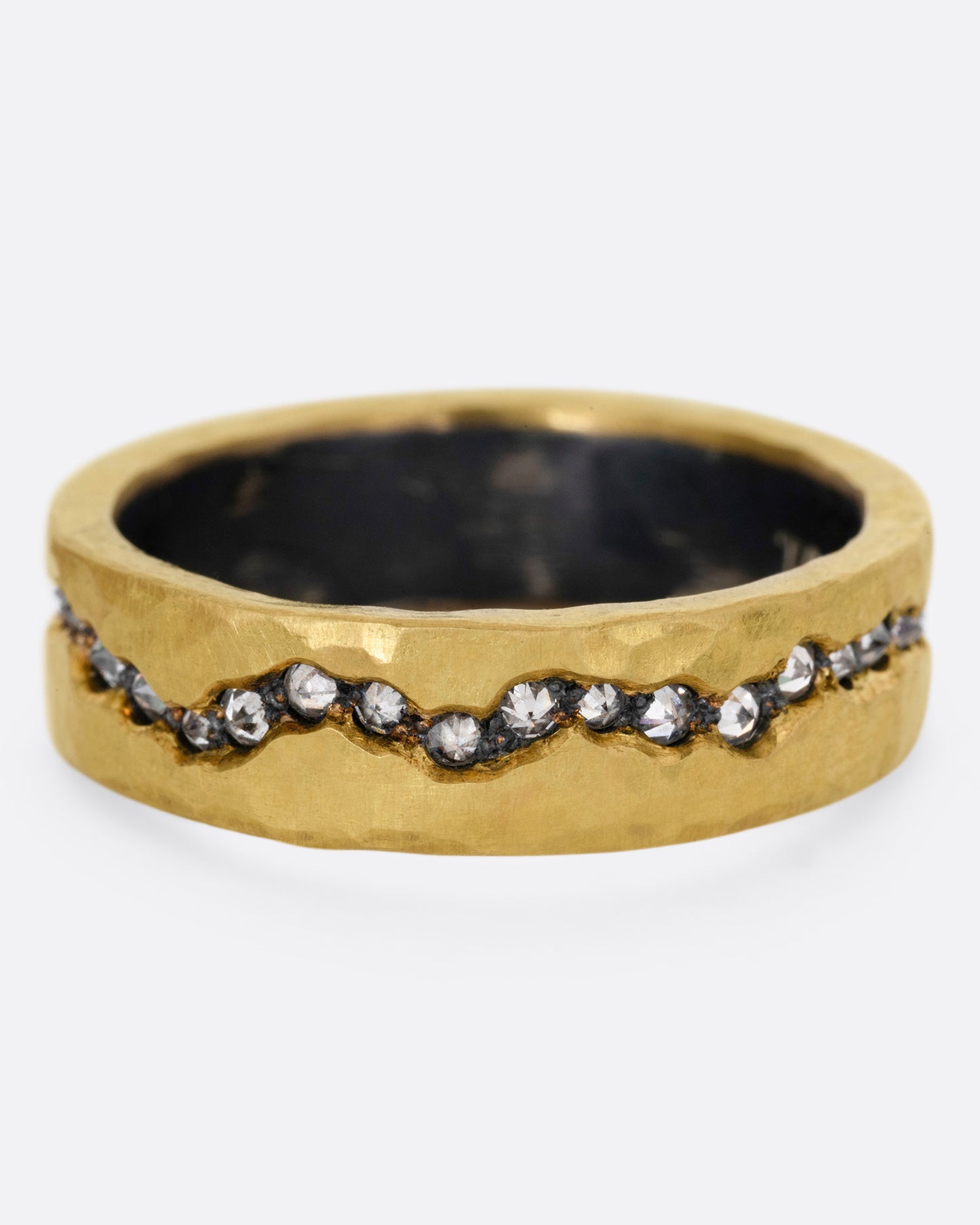 An oxidized silver ring with a yellow gold hammered finish and a fissure filled with inverted diamonds, shown from the front.