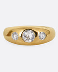 A yellow gold ring with three diamonds, shown from the front.