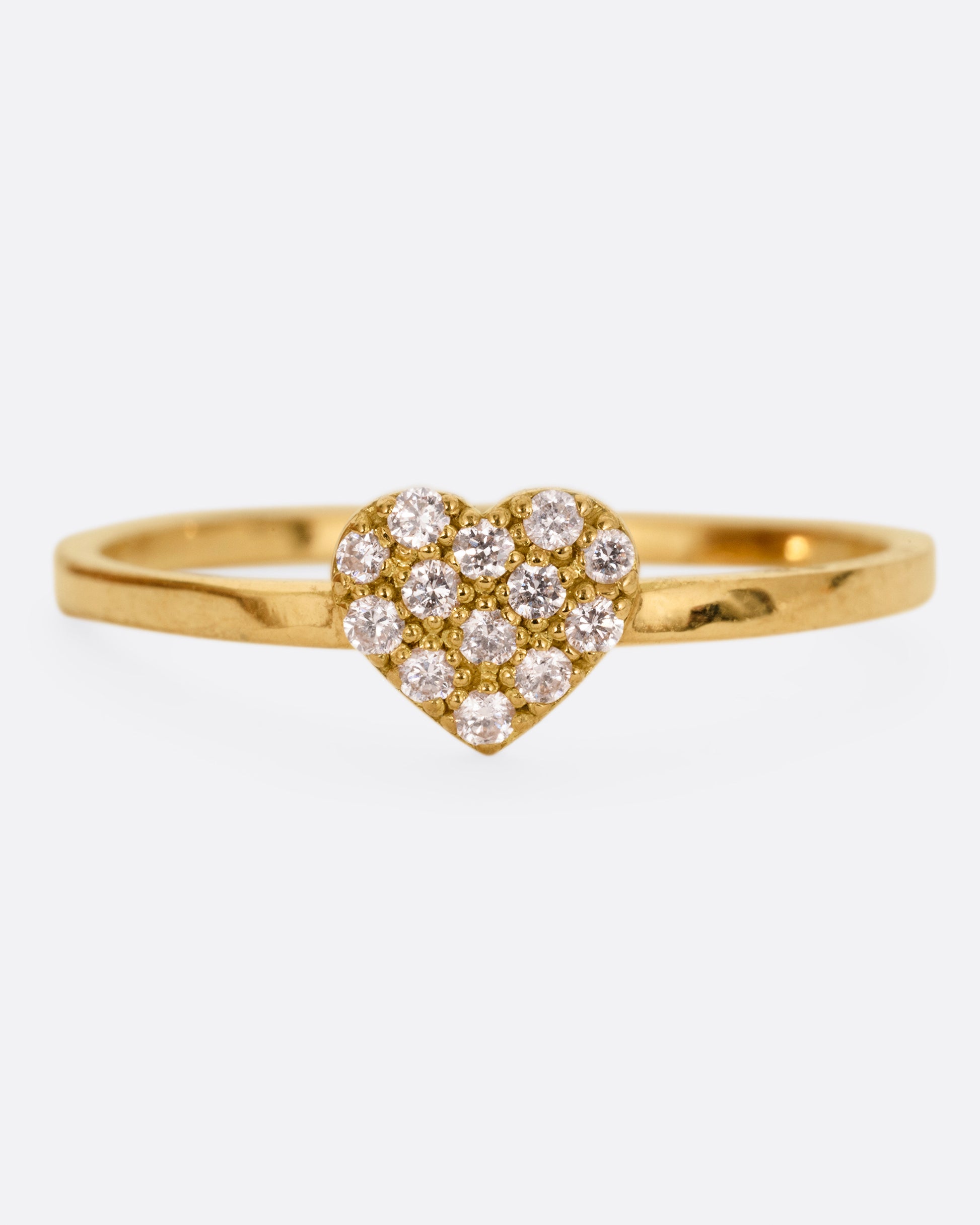 A yellow gold ring with a diamond studded heart. Shown from the front.
