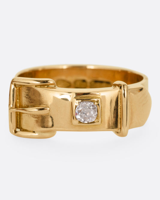 A yellow gold Victorian remembrance buckle ring with an old mine cut diamond. Shown from the front.