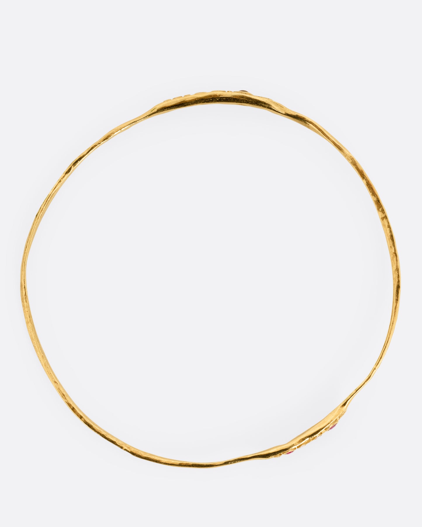 A yellow gold bracelet shown from the top.