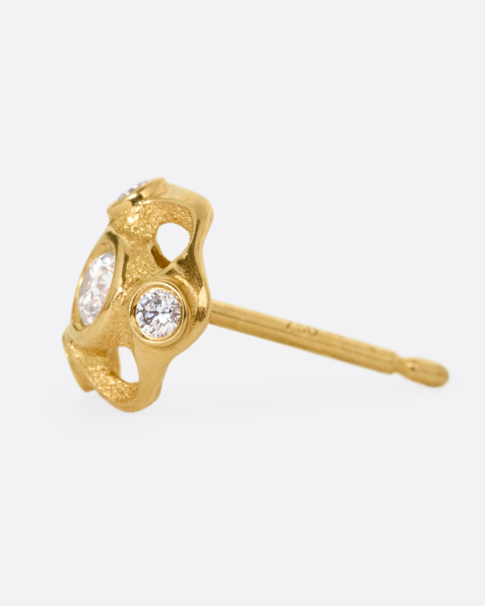 A yellow gold stud earring with four brilliant cut diamonds, shown from the side.