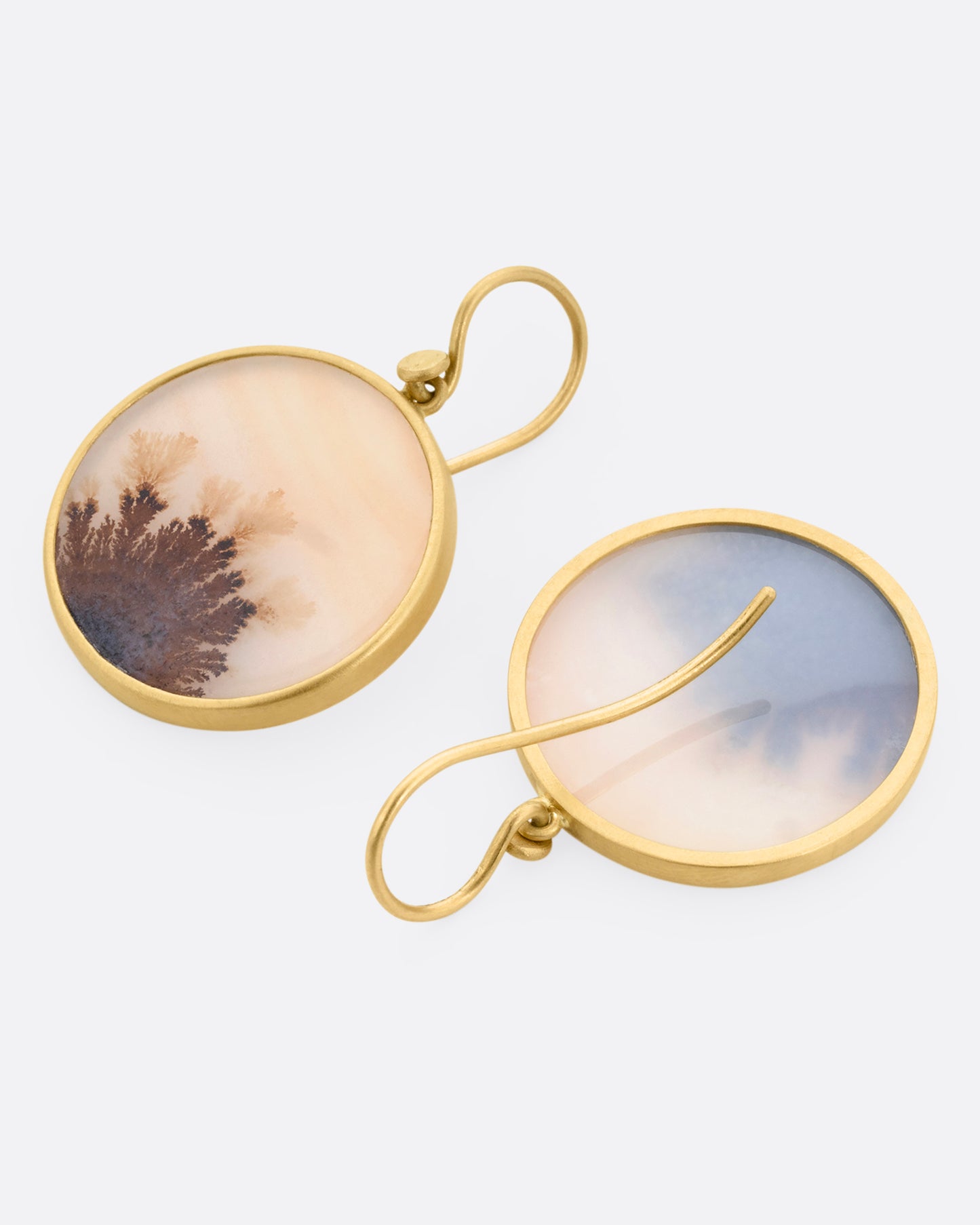 A pair of yellow gold dendritic agate earrings. One earring is shown from the front, the other is shown from the back.