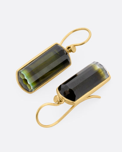 Yellow gold green tourmaline drop earrings, the pair laid flat