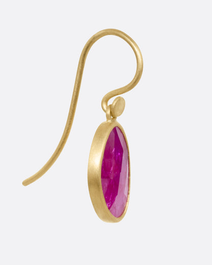 Yellow gold ruby drop earrings, side view showing the hook wire and bezel
