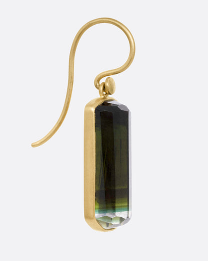 Yellow gold green tourmaline drop earrings, side view showing the hook wire and bezel