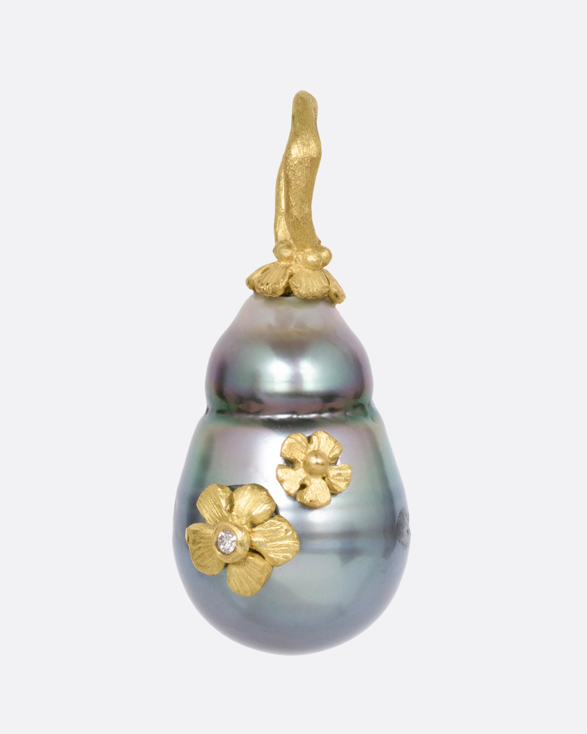 A yellow gold  Tahitian pearl pendant with diamond accented flower details, shown from the front.