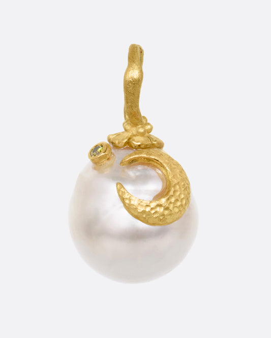 A yellow gold South Sea pearl pendant with a floral vine bail, a crescent moon, and a tiny diamond star. Shown from the front.