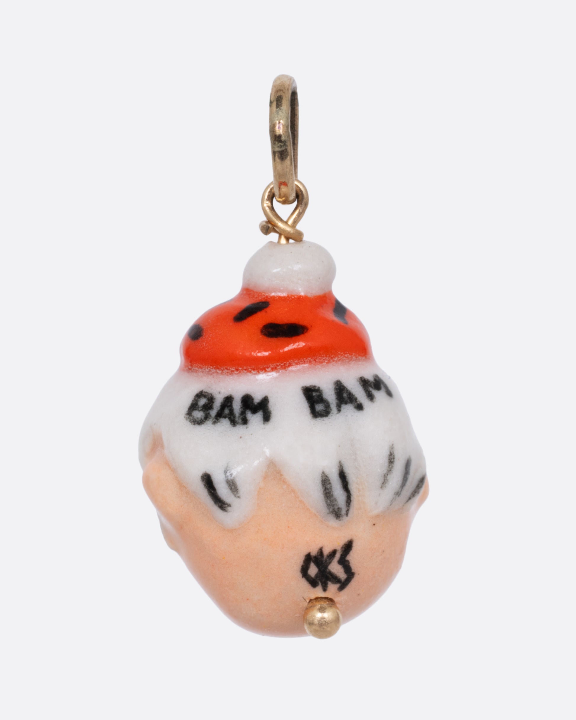 A yellow gold pendant with a porcelain Bamm-Bamm Rubble, shown from the back.