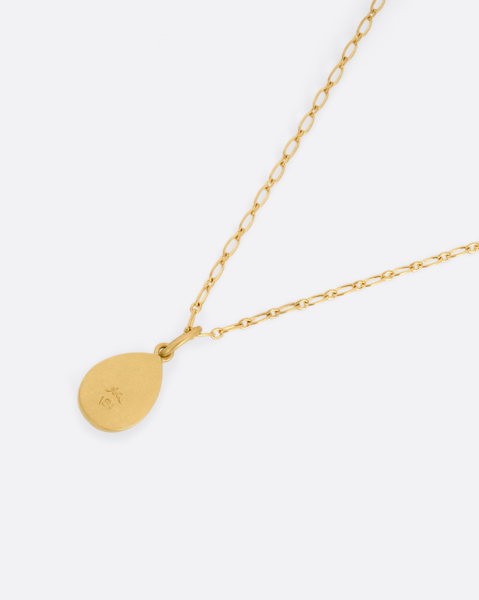 A yellow gold elongated link cable chain necklace with a teardrop shaped salt and pepper diamond, shown from the back.