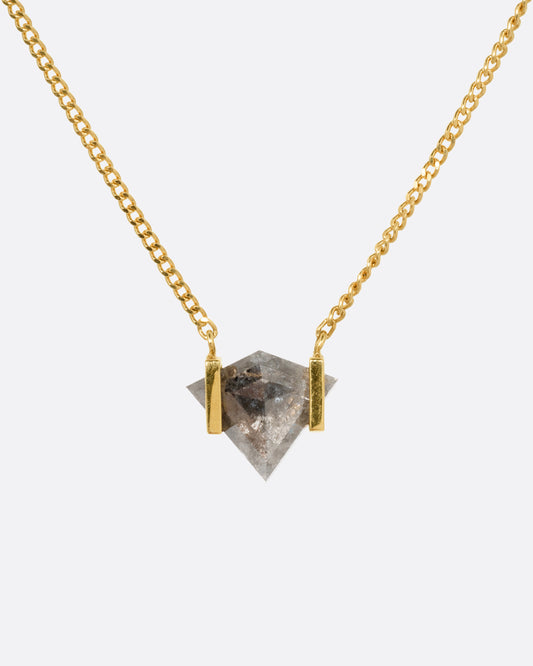 A yellow gold necklace with a salt and pepper diamond pendant, shown from the front.