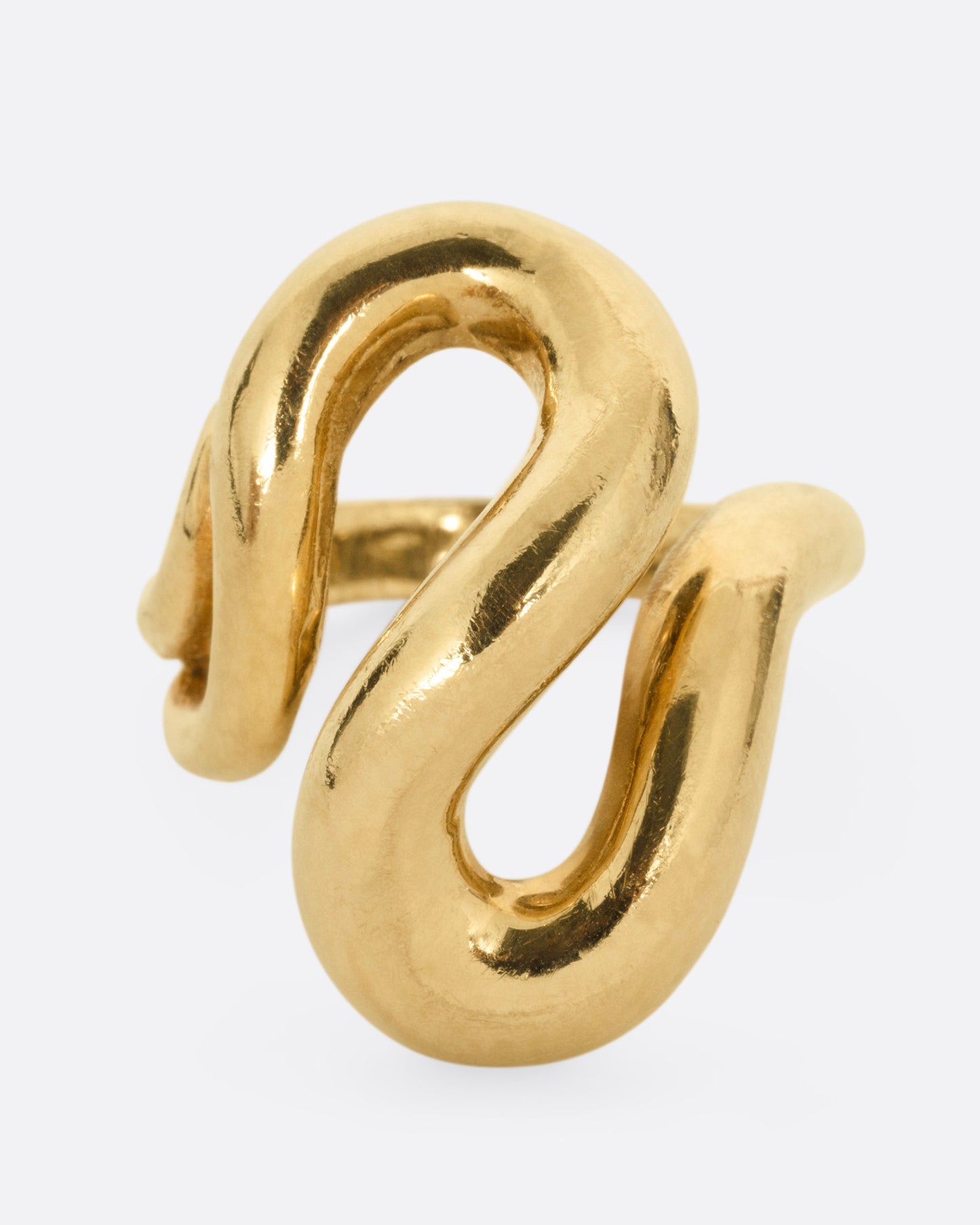 A yellow gold coiling ring, shown from the front.