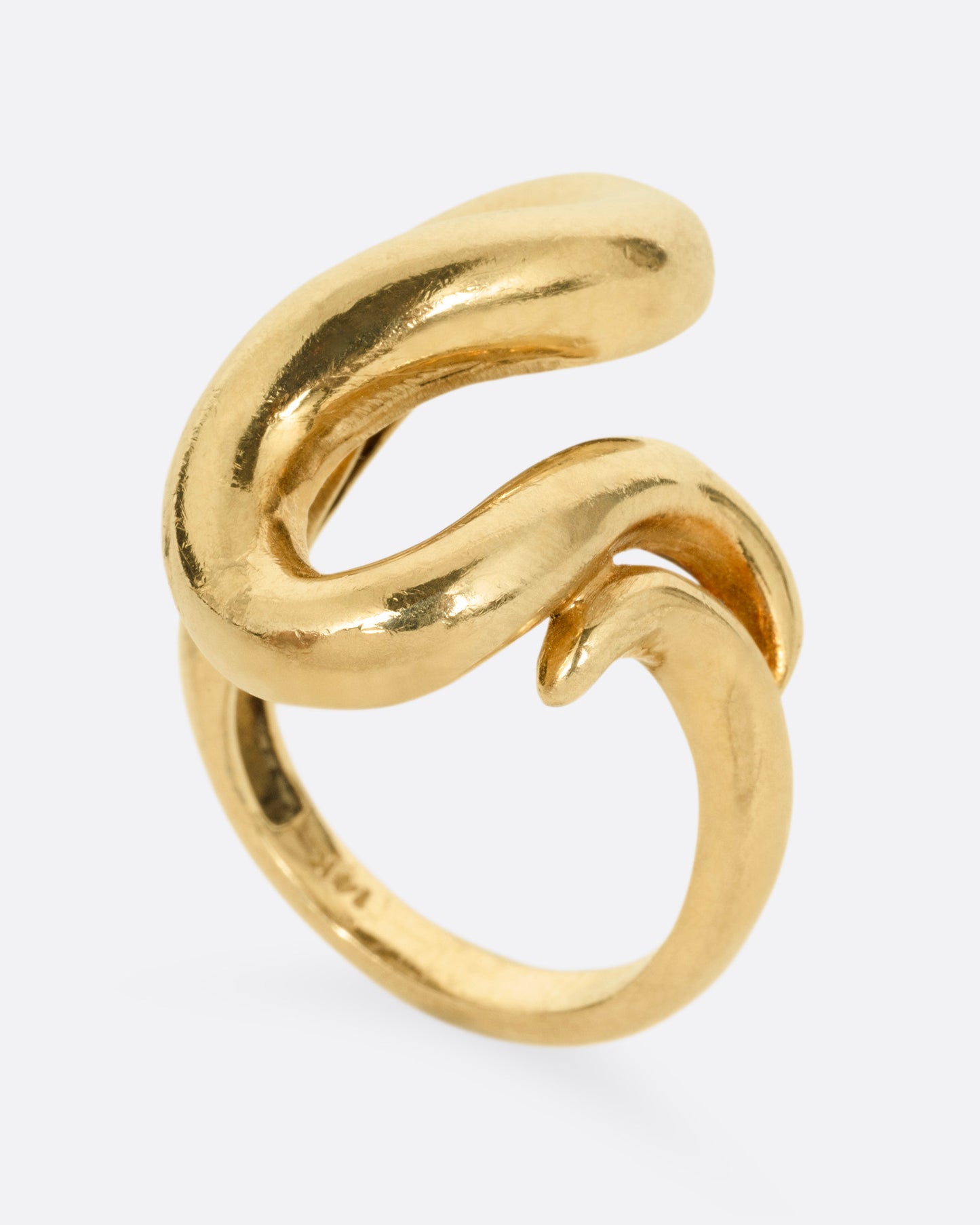 A yellow gold coiling ring, shown from the side standing up.