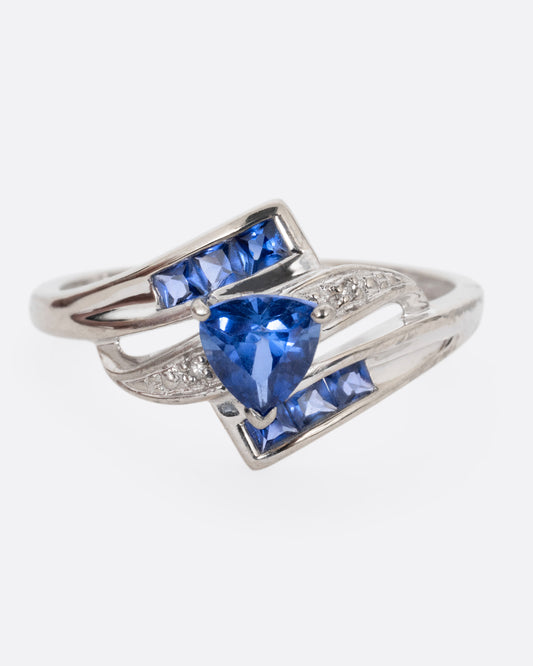 A white gold wrap wring with diamonds and sapphires, shown from the front.