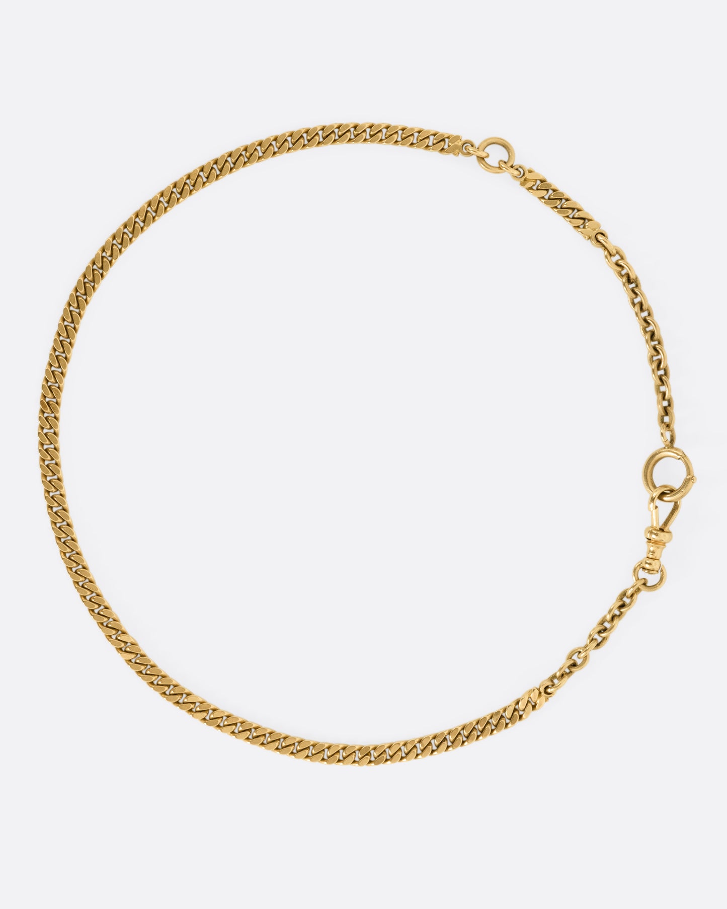 A yellow gold curb chain necklace, shown from the front.