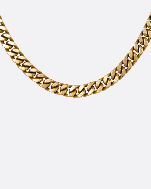 A yellow gold curb chain necklace, shown from the front.