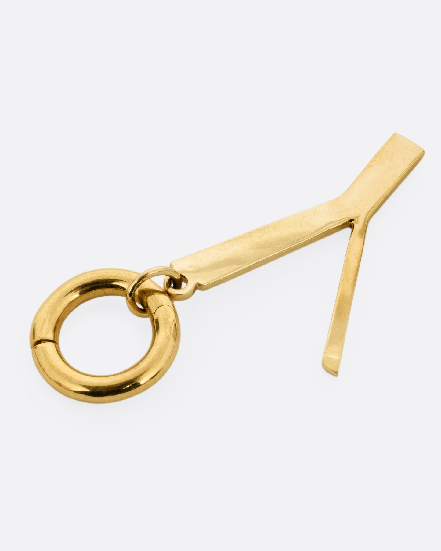 A yellow gold 'Y' shaped pendant, shown from the side.