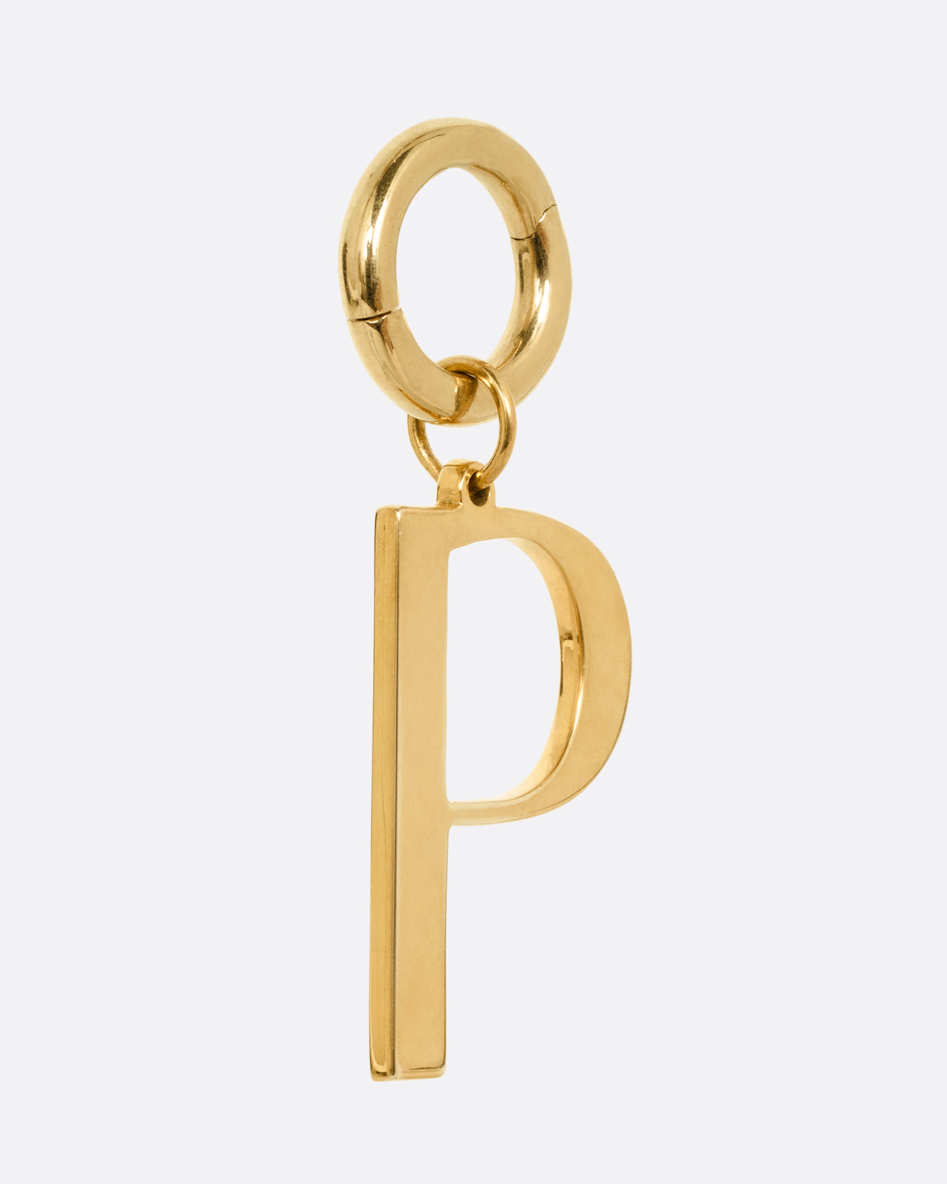 A yellow gold 'P' shaped pendant, shown from the side.