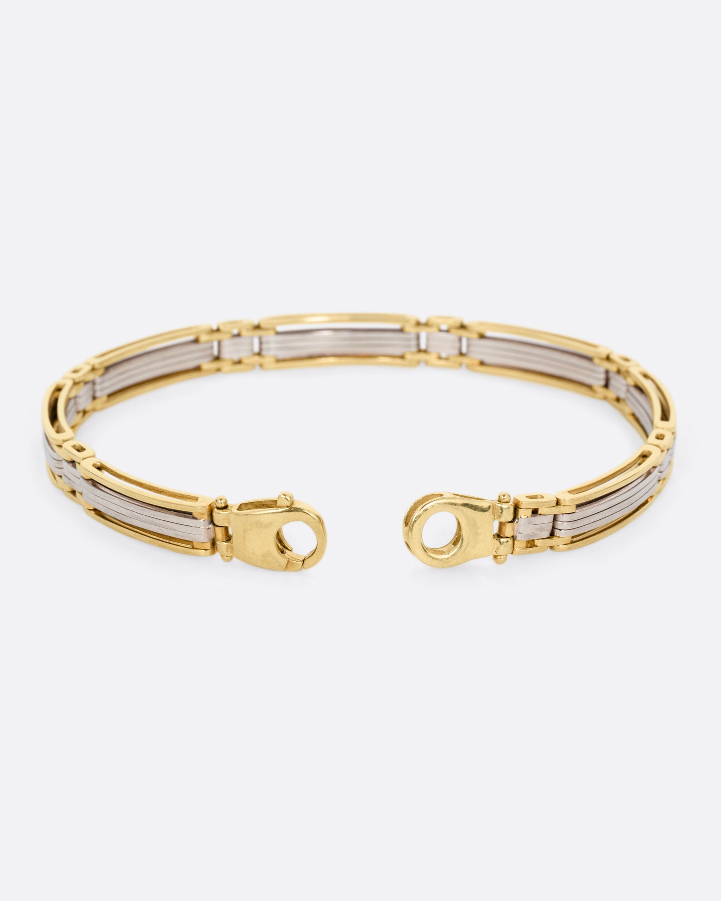 A yellow and white gold link bracelet, shown open from the back.