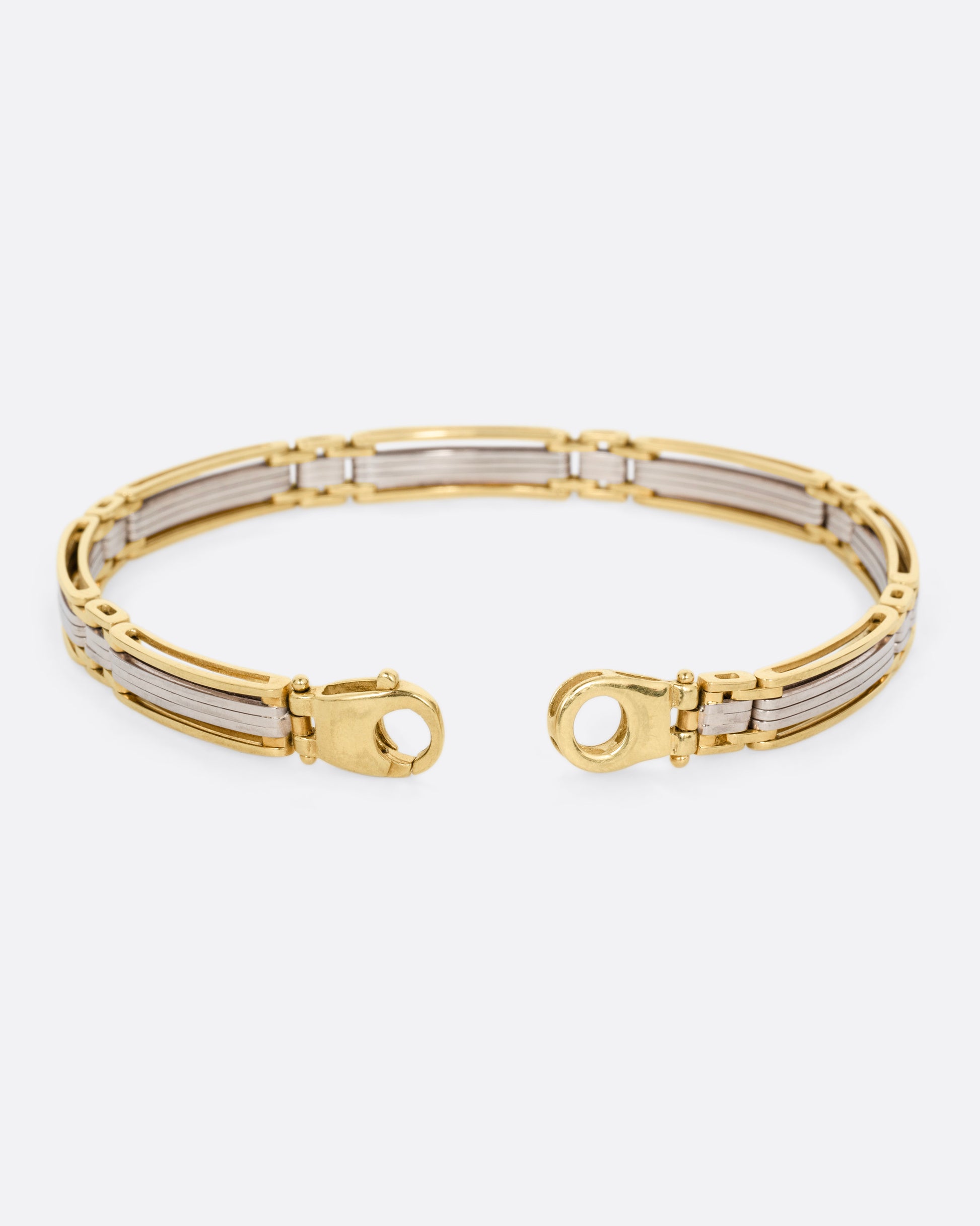 A yellow and white gold link bracelet, shown open from the back.