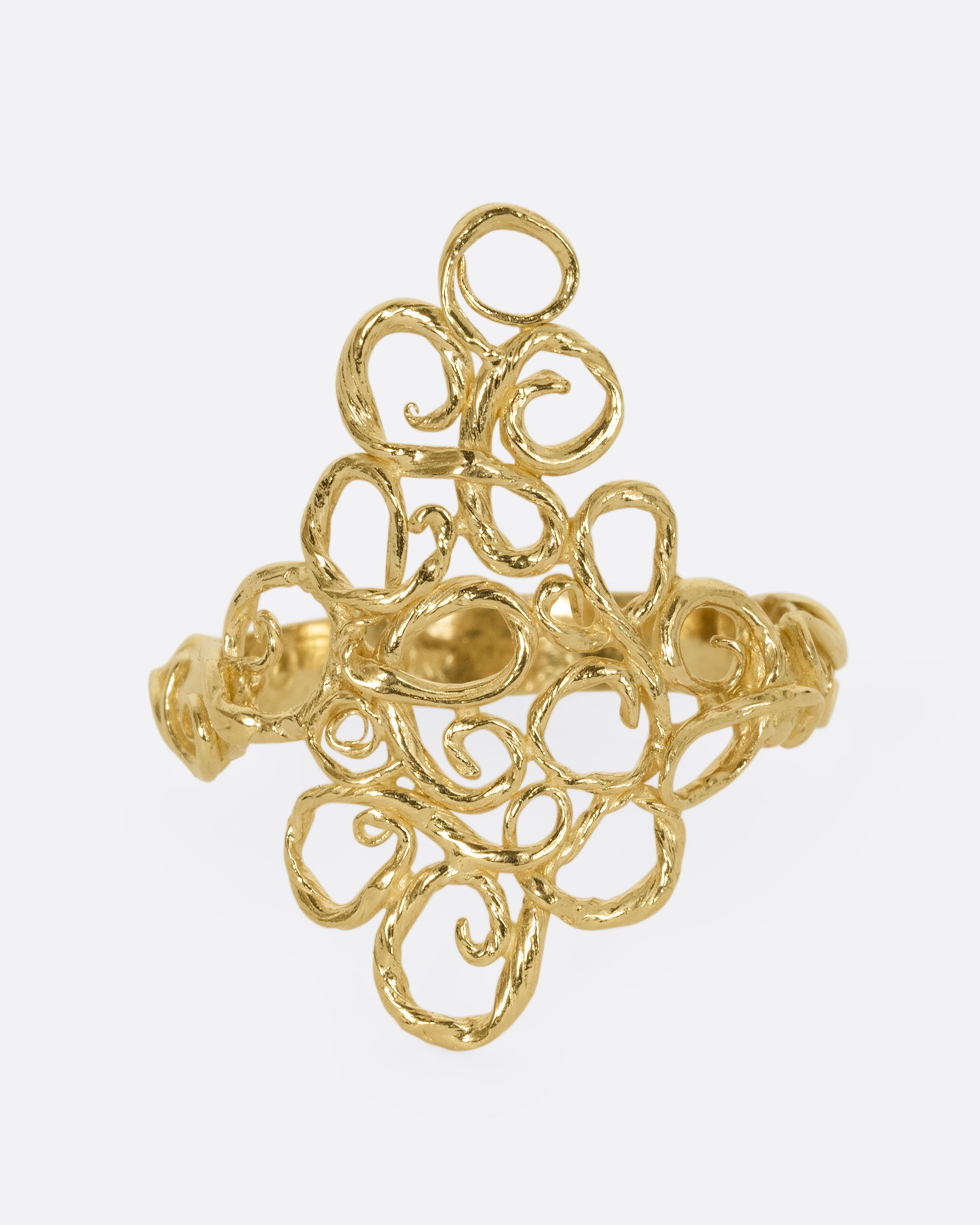 A yellow gold ring with filigree in the shape of a diamond at its center. Shown from the front.