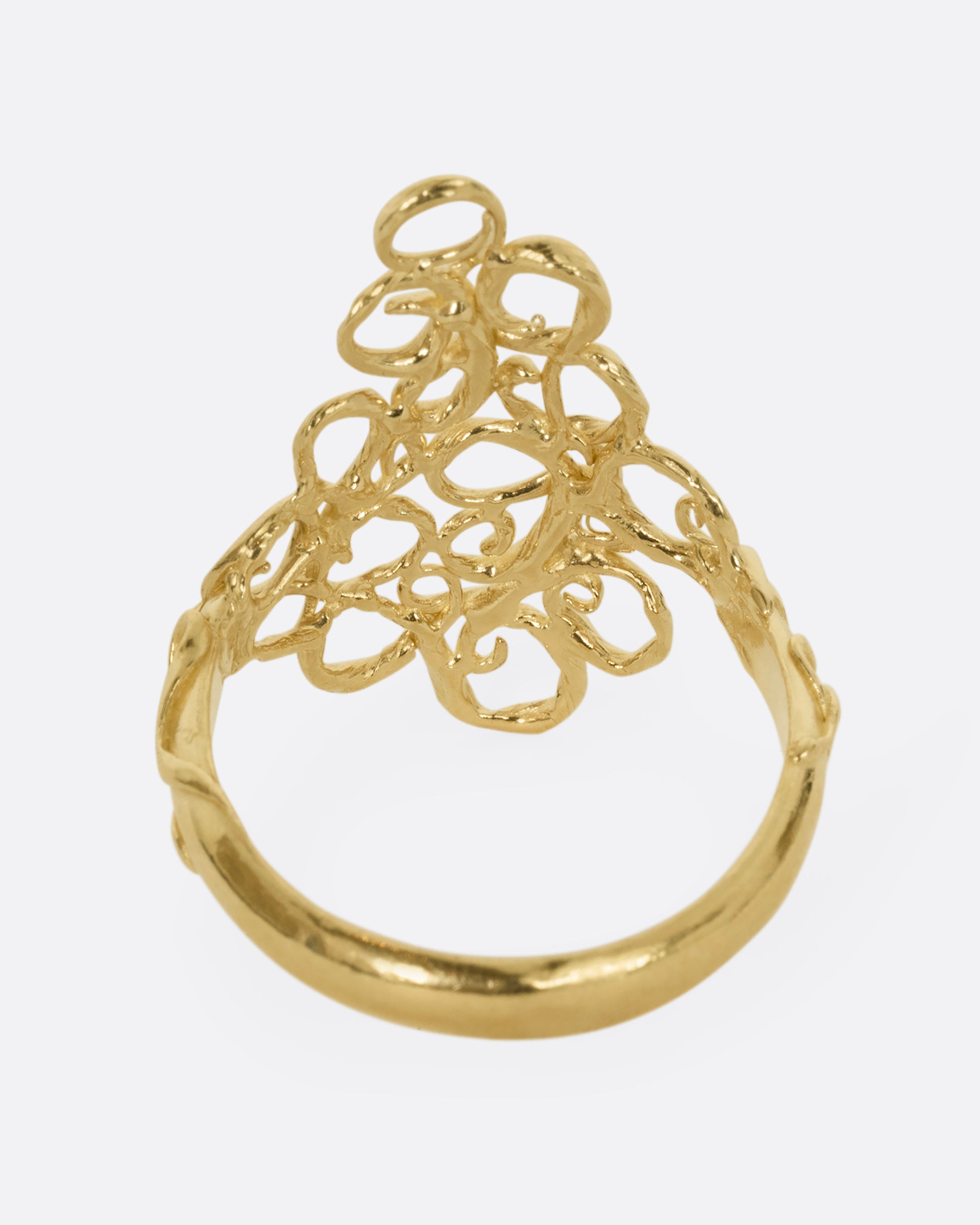 A yellow gold ring with filigree in the shape of a diamond at its center. Shown from the back.