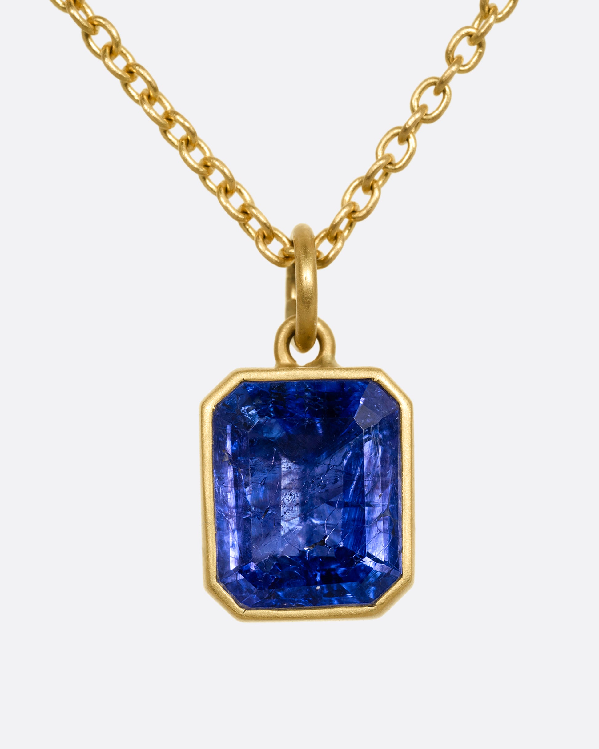 yellow gold necklace with an emerald cut tanzanite shown from the front