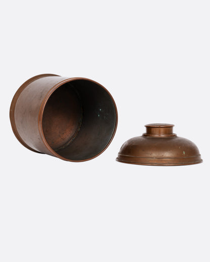 A brass humidor with a domed lid, shown lying on its side open from the top.