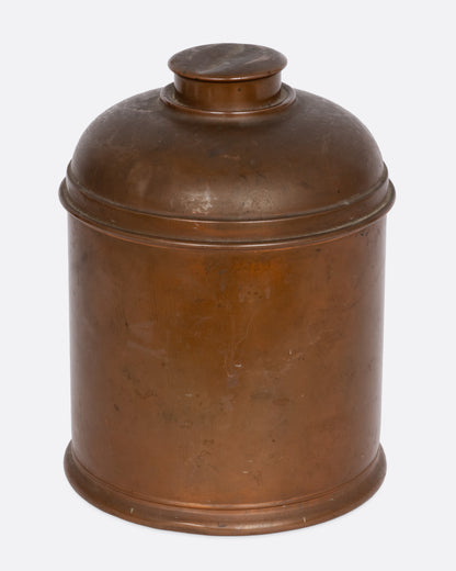 A brass humidor with a domed lid, shown from the front.