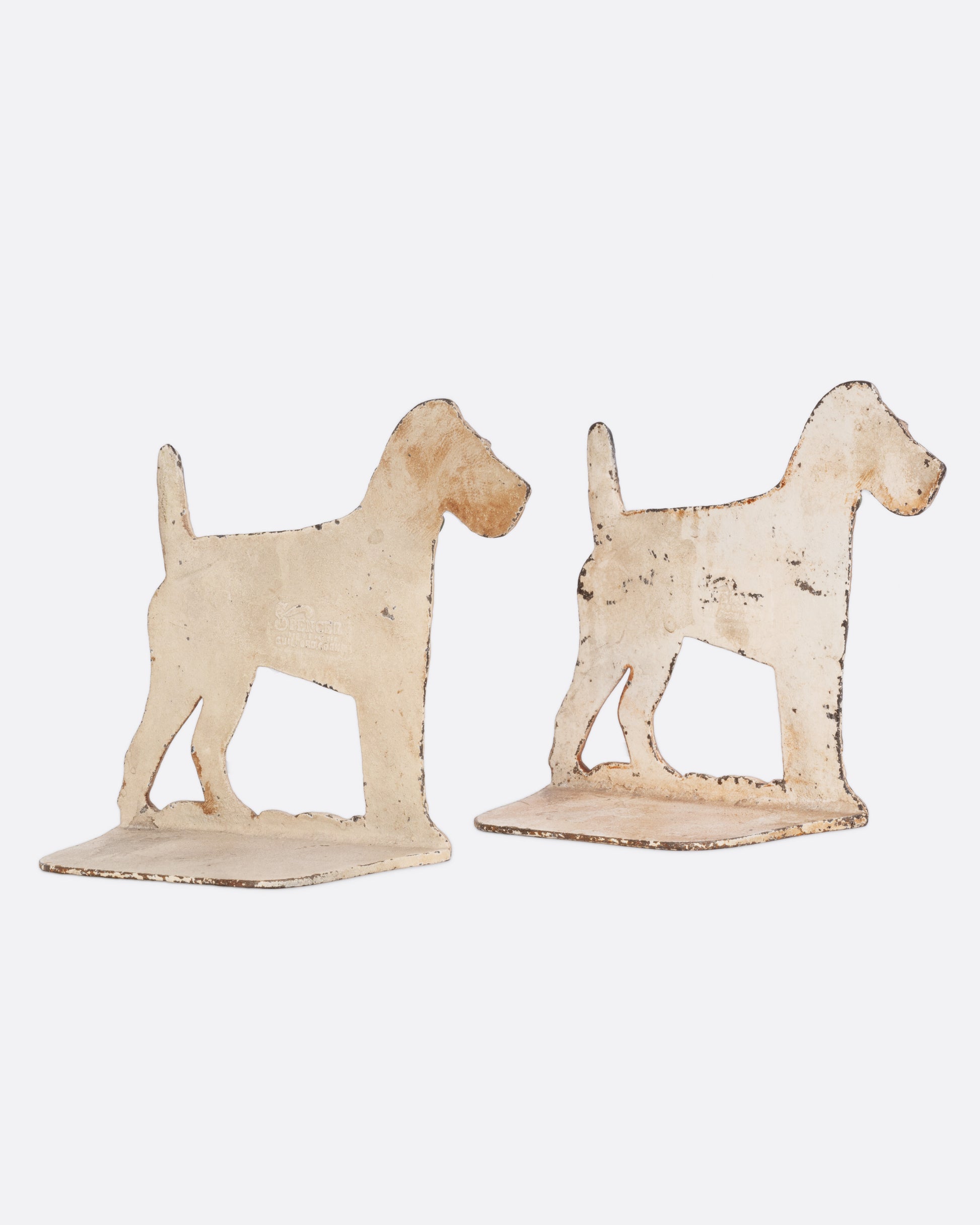 Two iron wire-haired fox terrier dog bookends, shown from the back.