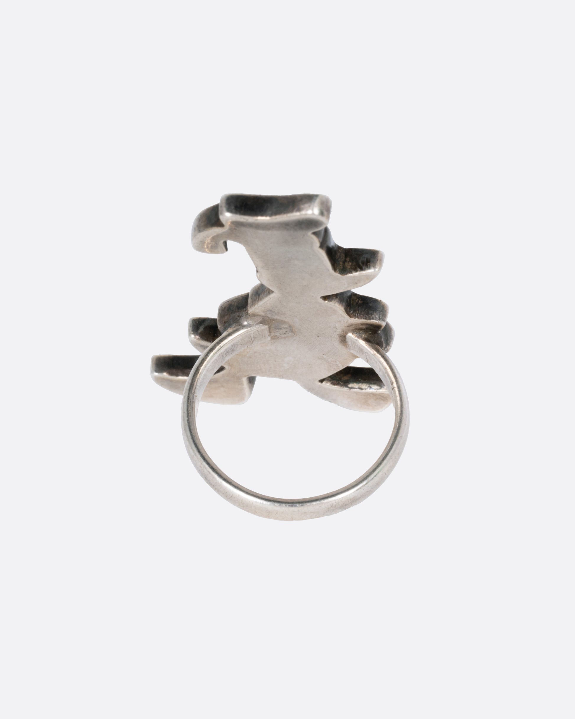 A Donald Duck ring with turquoise and mother-of-pearl inlay. Shown from the back.