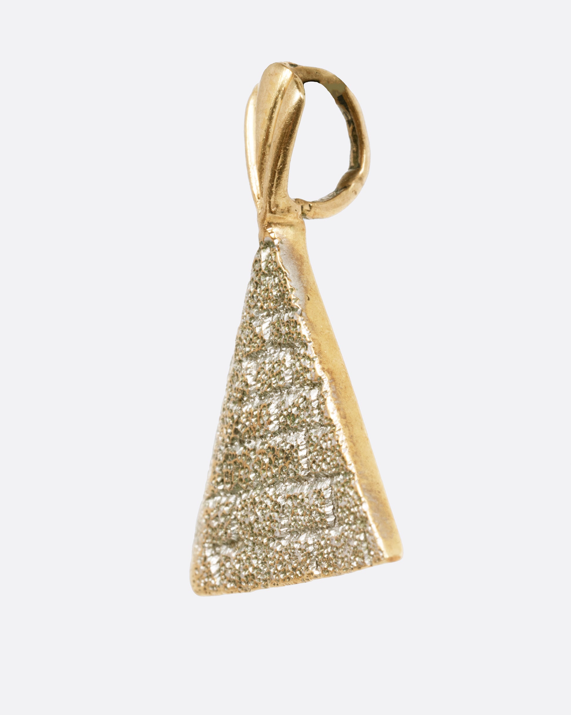 A yellow gold pyramid pendant shown from the side.