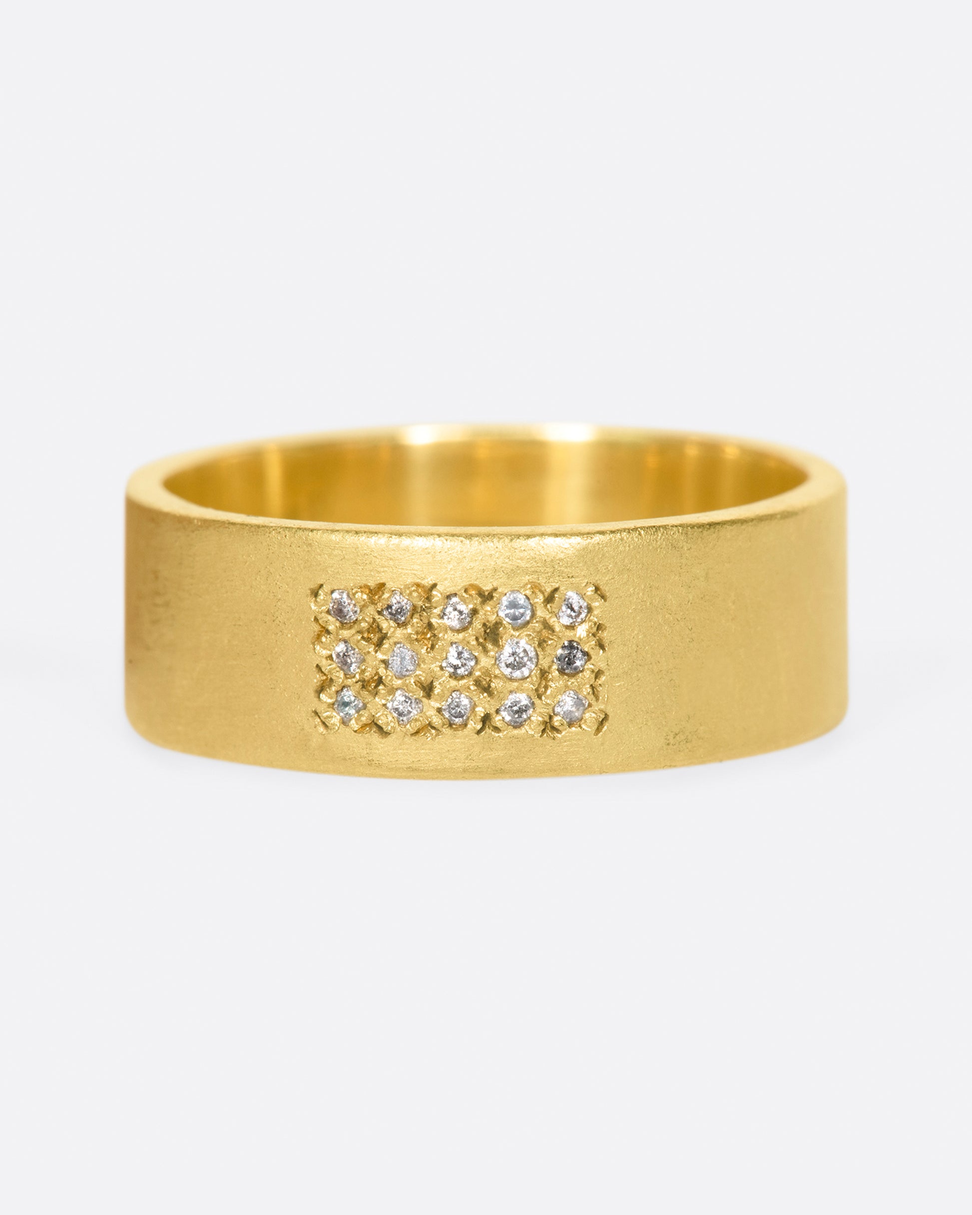 A yellow gold band with 15 grey diamonds in three rows of five at the center. Shown from the front.