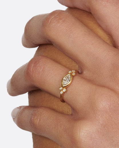 Yellow gold marquise diamond ring worn on a hand
