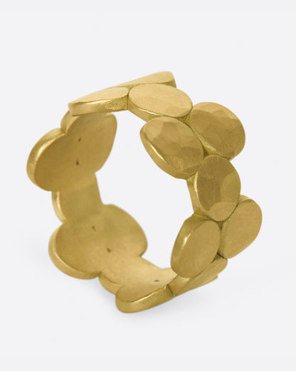 Matte yellow gold disc band, angled view showing the hammered discs linked around the band