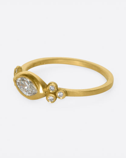 Yellow gold marquise diamond ring, side view with the marquise diamond facing left