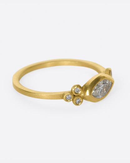 Yellow gold marquise diamond ring, side view with the marquise diamond facing right