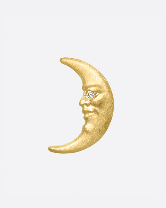 A yellow gold crescent moon stud earring with a face and a diamond eye. Shown from the front.