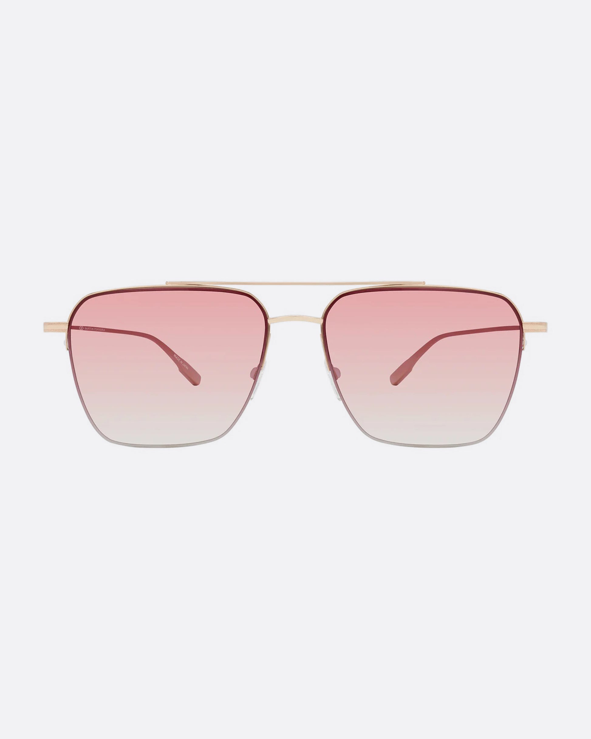 A pair of navigator sunglasses with pink gradient lenses. Shown from the front.