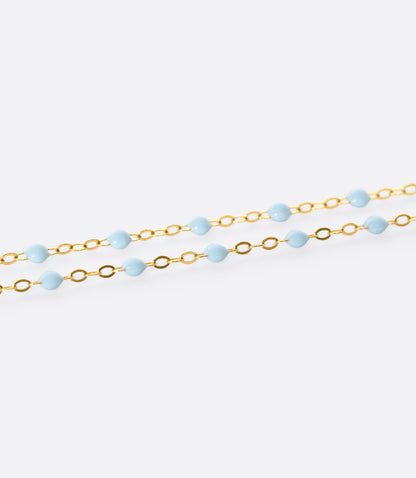 Rose gold resin bead bracelet, shown in light blue resin