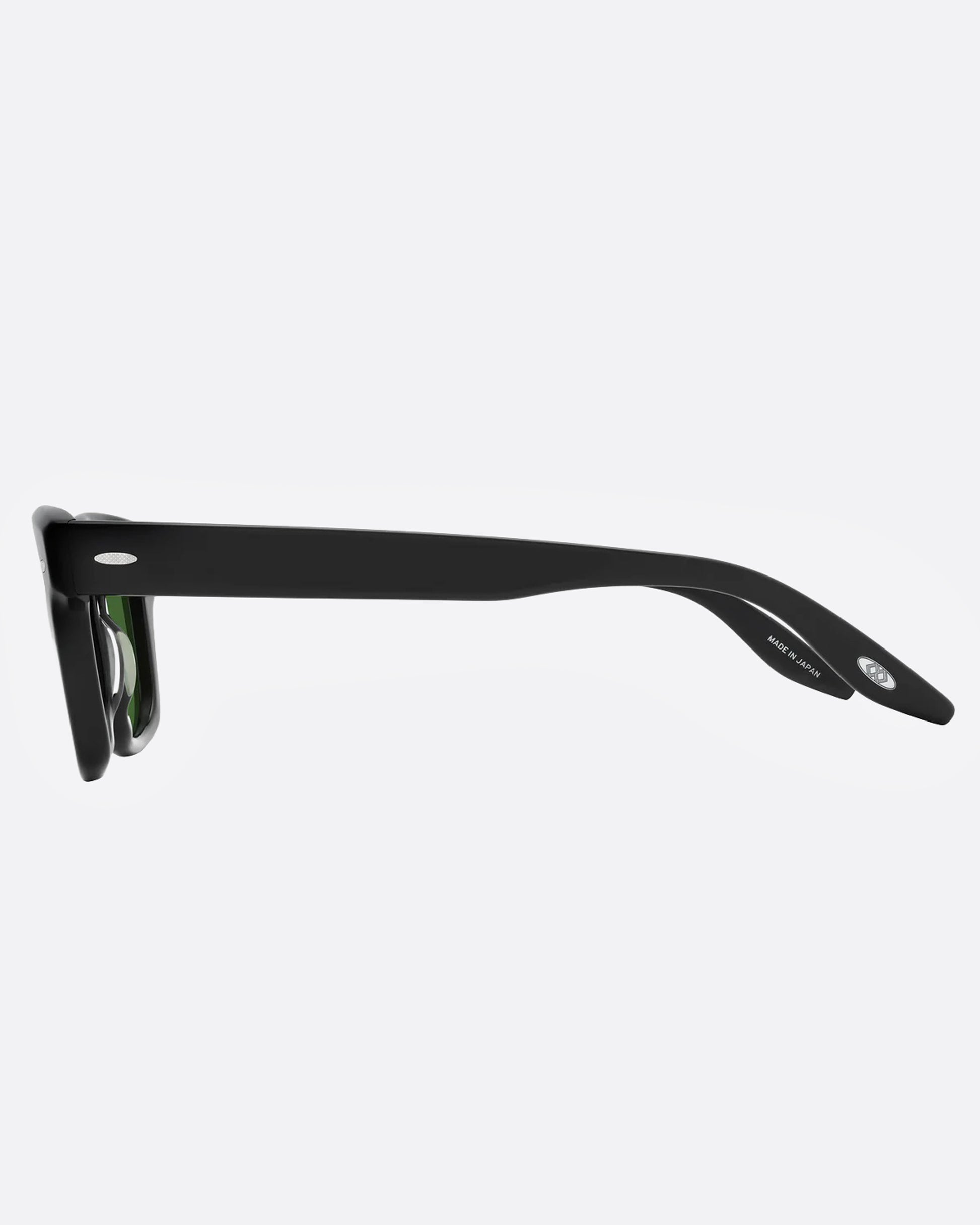 A pair of black sunglasses with green lenses, shown from the side.