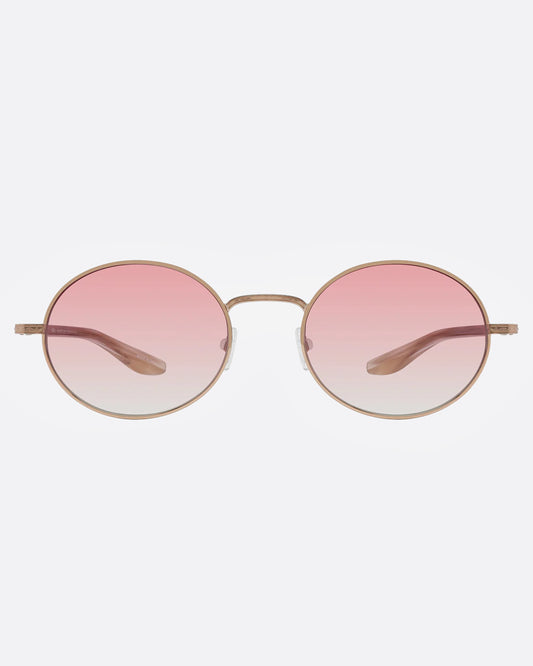 A pair of rose gold sunglasses with oval-shaped pink ombré lenses, shown from the front.