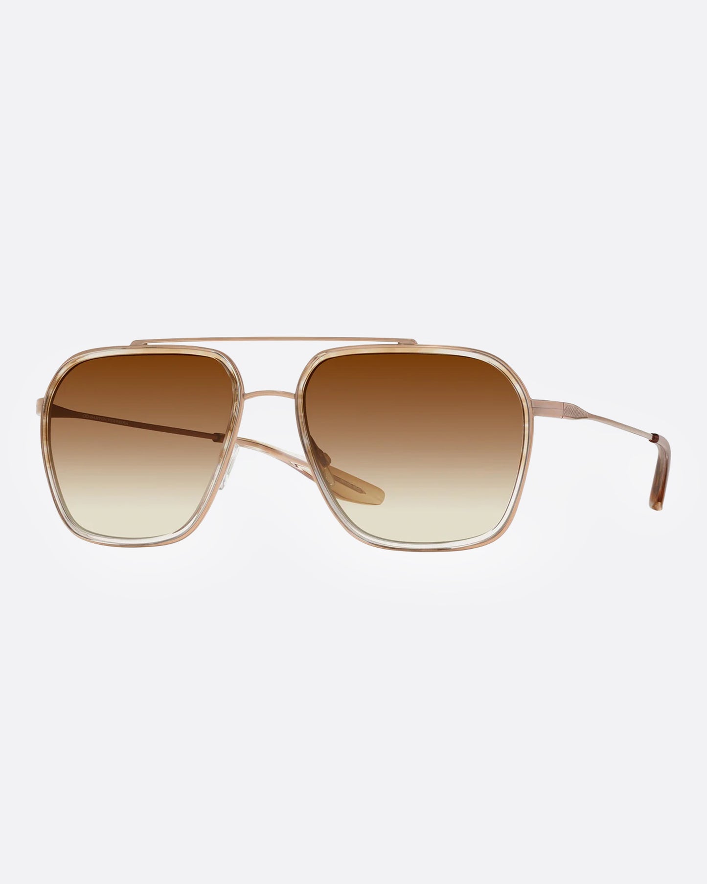 A pair of gold-framed aviator sunglasses with brown gradient lenses, shown from the side.