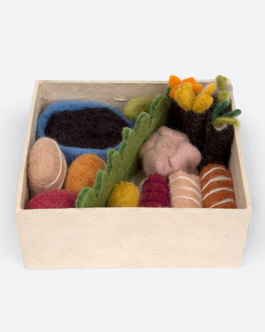 A toy bento box with a felt sushi set, arranged to look like a meal. Shown from the top.