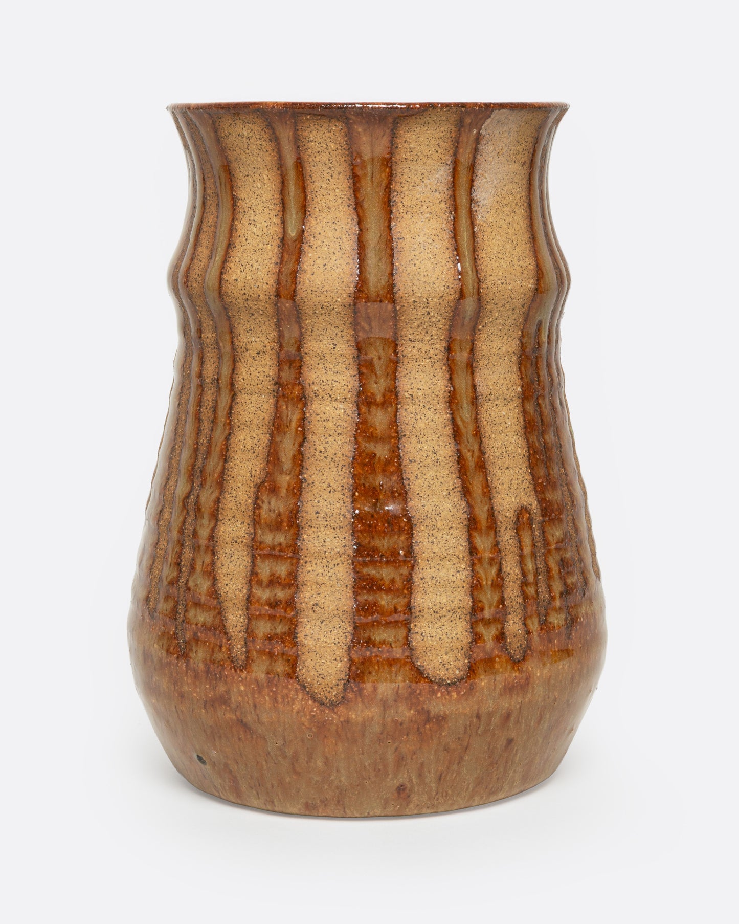 A tan ceramic vase with a dripped umber glaze, shown from the front.
