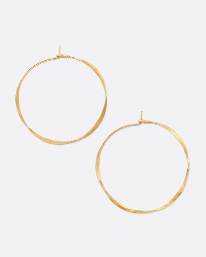 Gold wire round hoop earrings, the pair laid flat